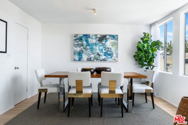 a view of a dining room with furniture and a potted plant