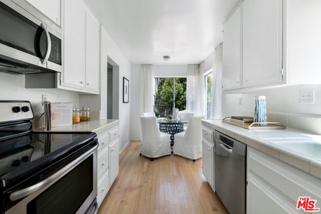 a kitchen with a stove sink and microwave