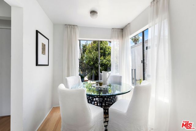 a view of a dining room with furniture wooden floor and a chandelier