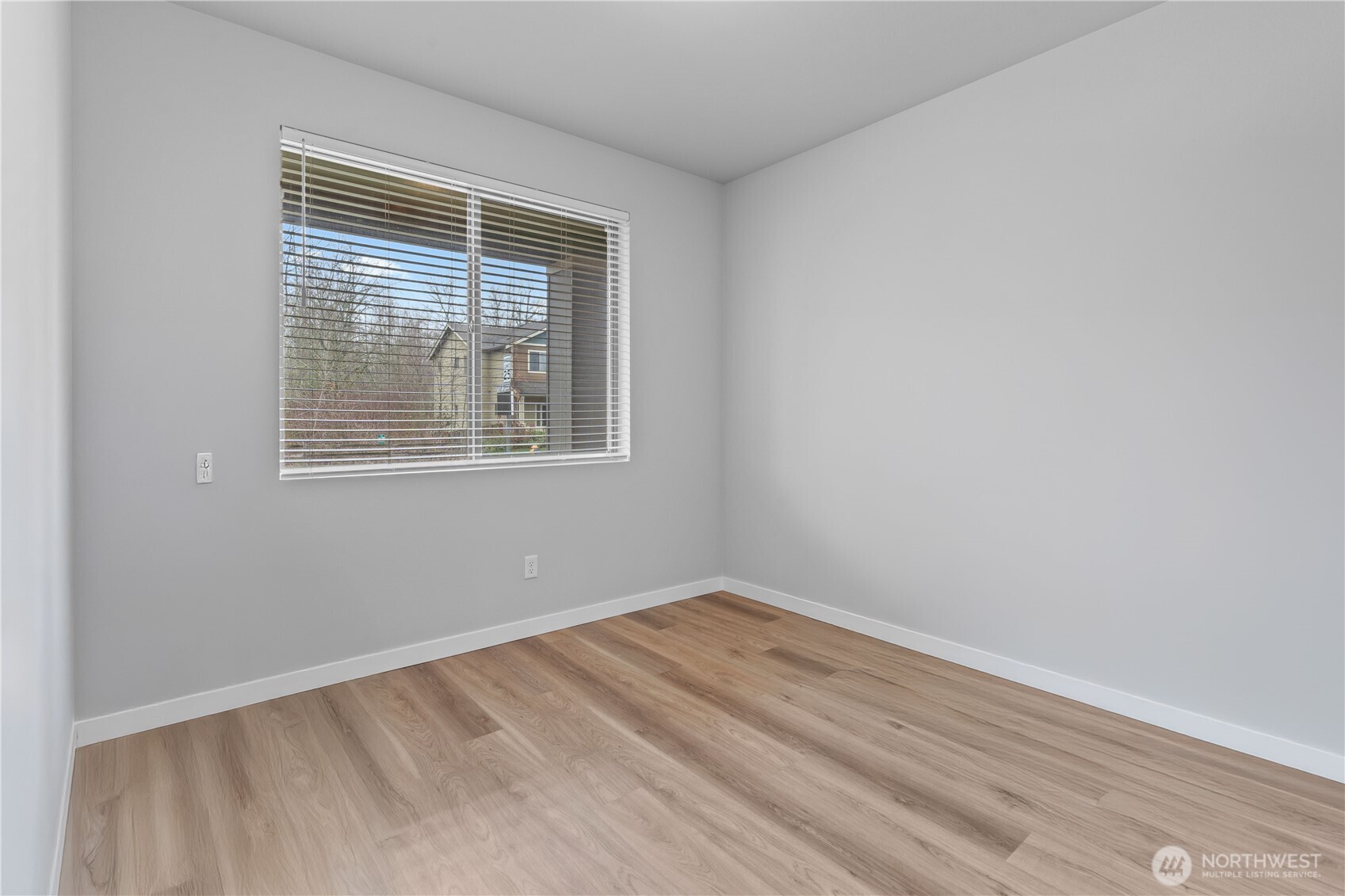342 South Spruce Street Buckley, WA 98321 - Photo 15 of 34 a view of an empty room with wooden floor and a window