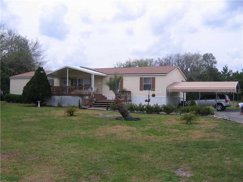 4445 Fox Ridge Boulevard Wesley Chapel, FL 33543 - Photo 1 of 1 a backyard of a house with table and chairs
