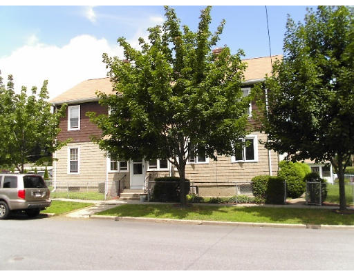 13-15 Lawrence Road Chicopee, MA 01013 - Photo 1 of 11 a white house that has a tree in front of it