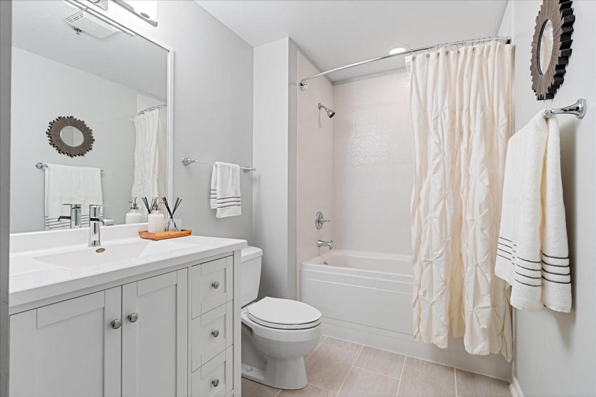 1040 West Adams Street, Unit 344 Chicago, IL 60607 - Photo 15 of 31 a bathroom with a sink a toilet and shower