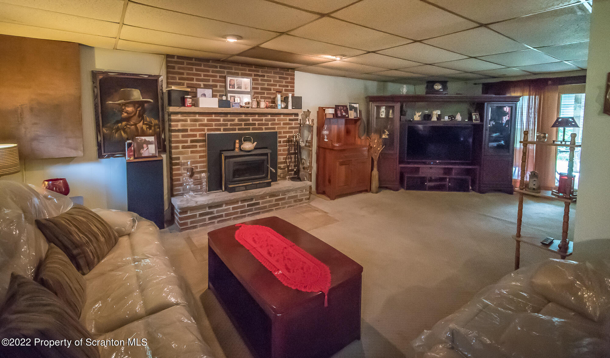 1971 Becks Crossing Road Moscow, PA 18444 - Photo 20 of 31 a living room with furniture a ceiling fan and a fireplace