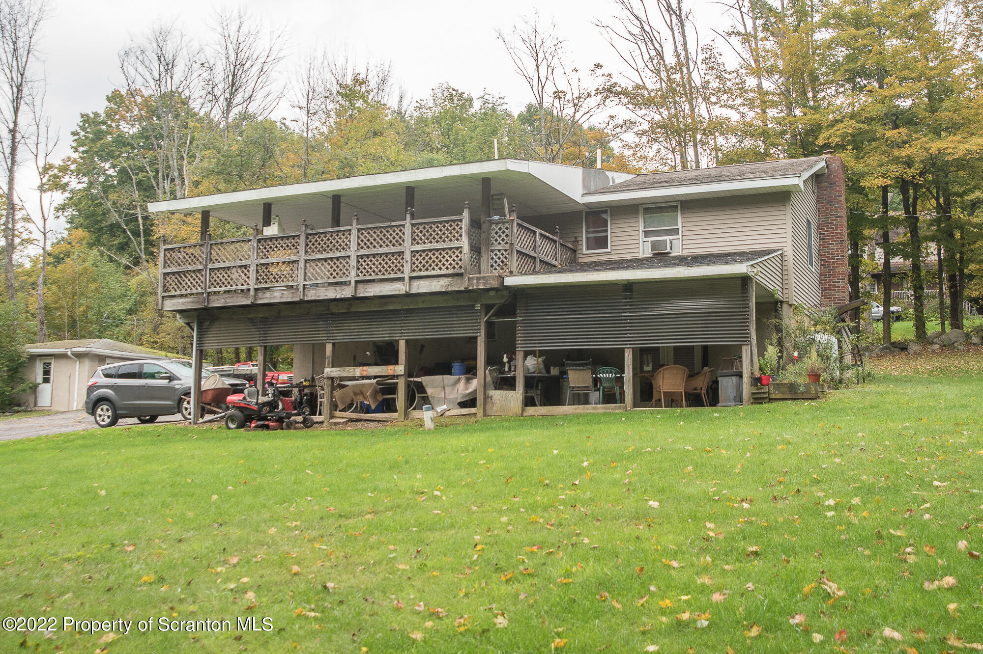 1971 Becks Crossing Road Moscow, PA 18444 - Photo 28 of 31 a view of a house with sitting area and trees around