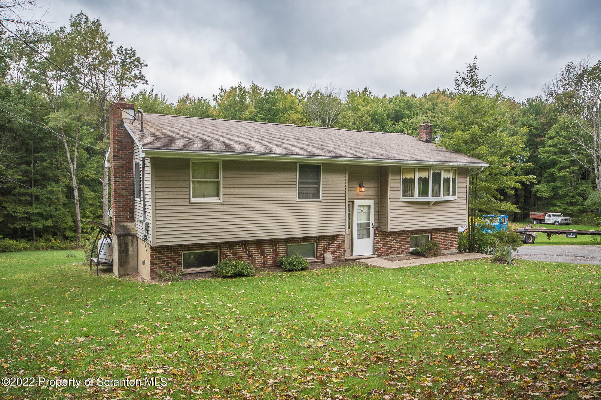 1971 Becks Crossing Road Moscow, PA 18444 - Photo 30 of 31 a front view of house with yard and outdoor seating