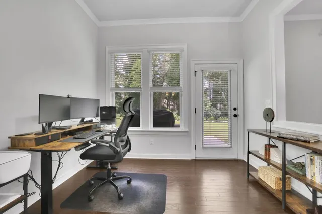 a view of a workspace with furniture and a window