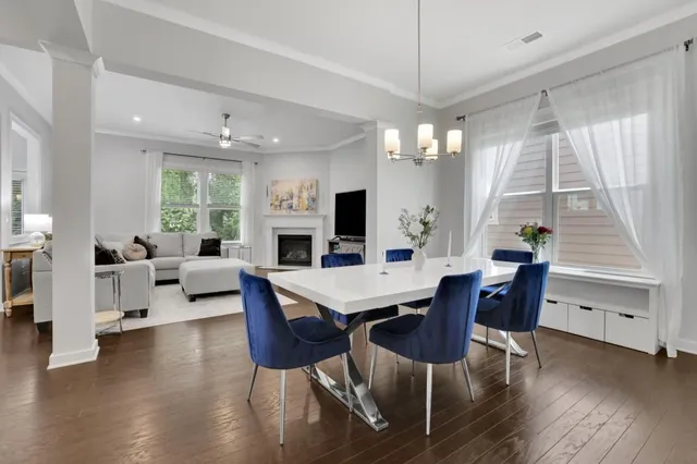 a view of a dining room with furniture window and wooden floor
