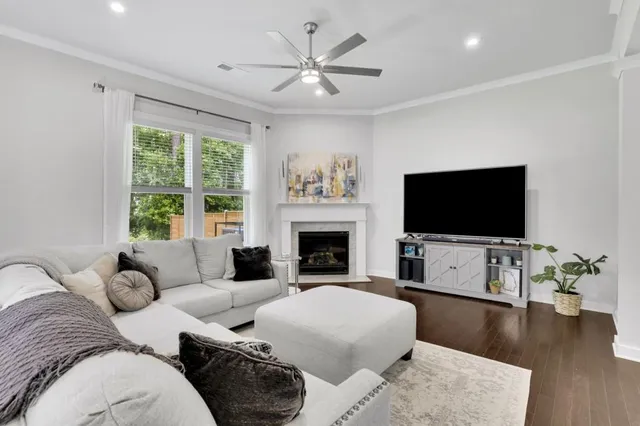 a living room with furniture a flat screen tv and a fireplace