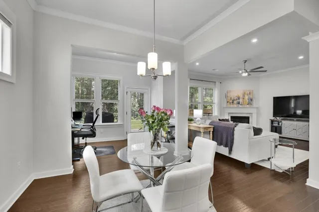 a view of a dining room with furniture a livingroom and chandelier