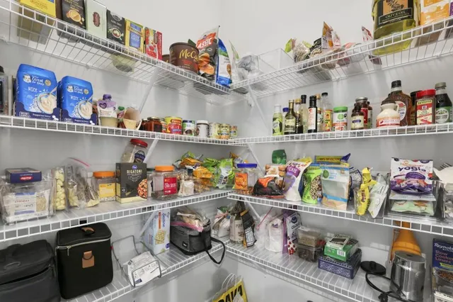 a utility room with lots of clutter and cabinets