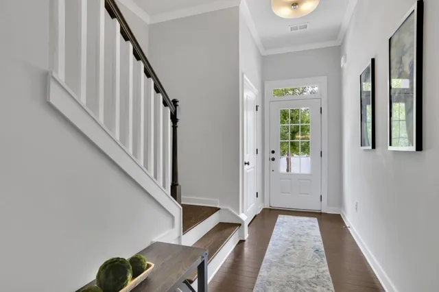 a view of entryway with wooden floor and stairs