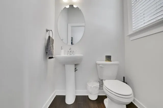 a bathroom with a toilet sink and mirror