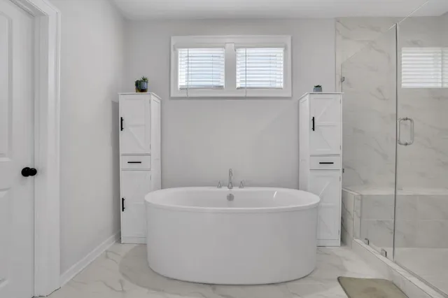 a white bath tub sitting in a bathroom