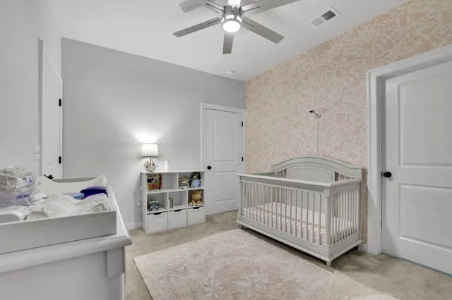 a bedroom with furniture and a baby crib