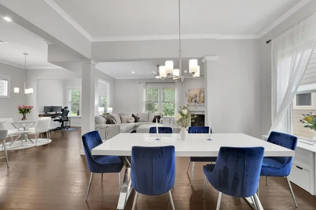 a view of a dining room with furniture wooden floor and chandelier