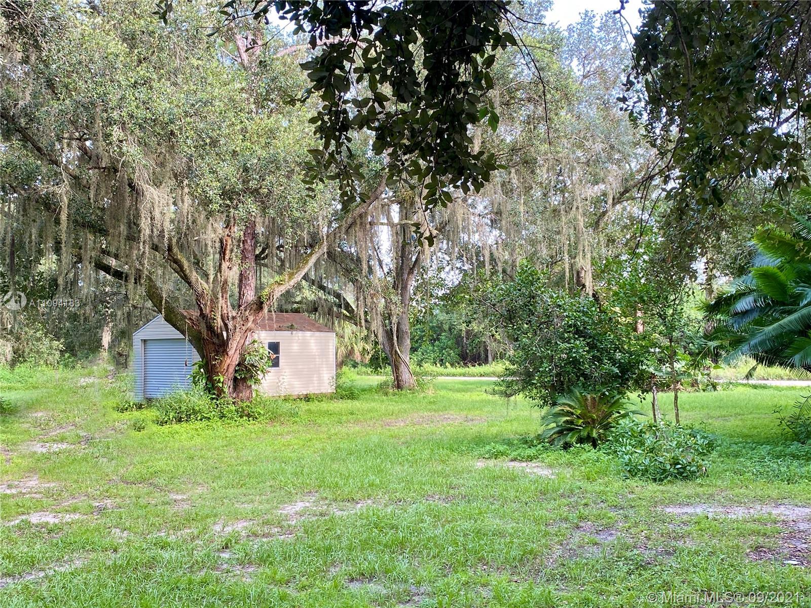 1600 G Road LaBelle, FL 33935 - Photo 3 of 7 a house with huge green field