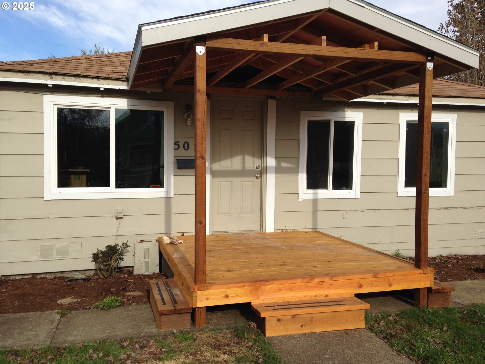 a view of house with backyard