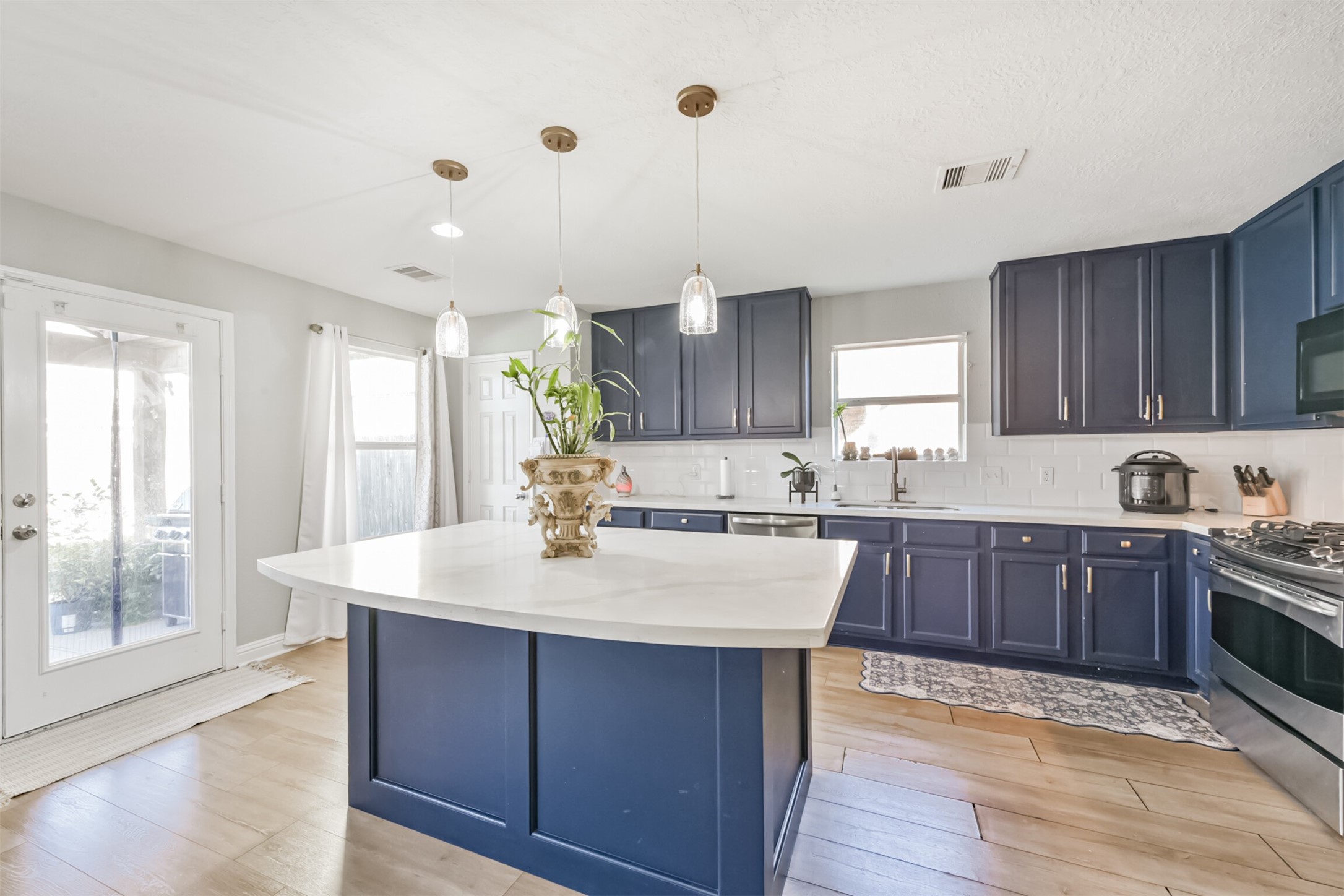 7015 Falling Cherry Place Houston, TX 77049 - Photo 13 of 42 a kitchen with a sink stove and wooden cabinets