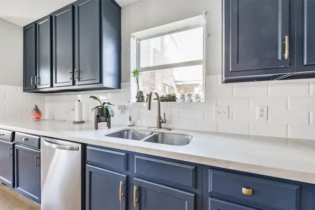 a kitchen with a sink cabinets and a window
