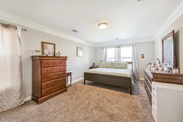 a bedroom with a bed and a dresser