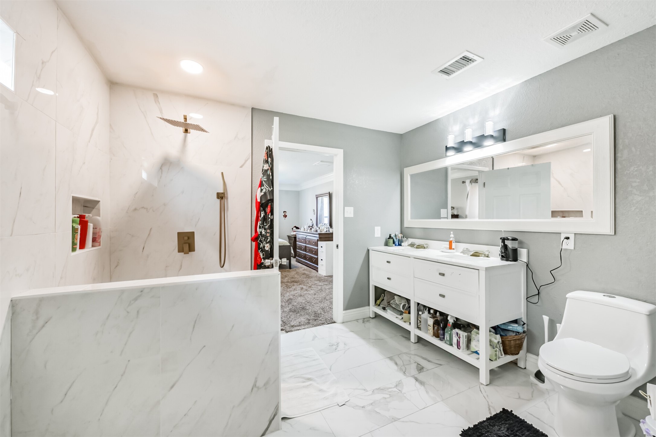 7015 Falling Cherry Place Houston, TX 77049 - Photo 22 of 42 a bathroom with a sink a toilet and a mirror