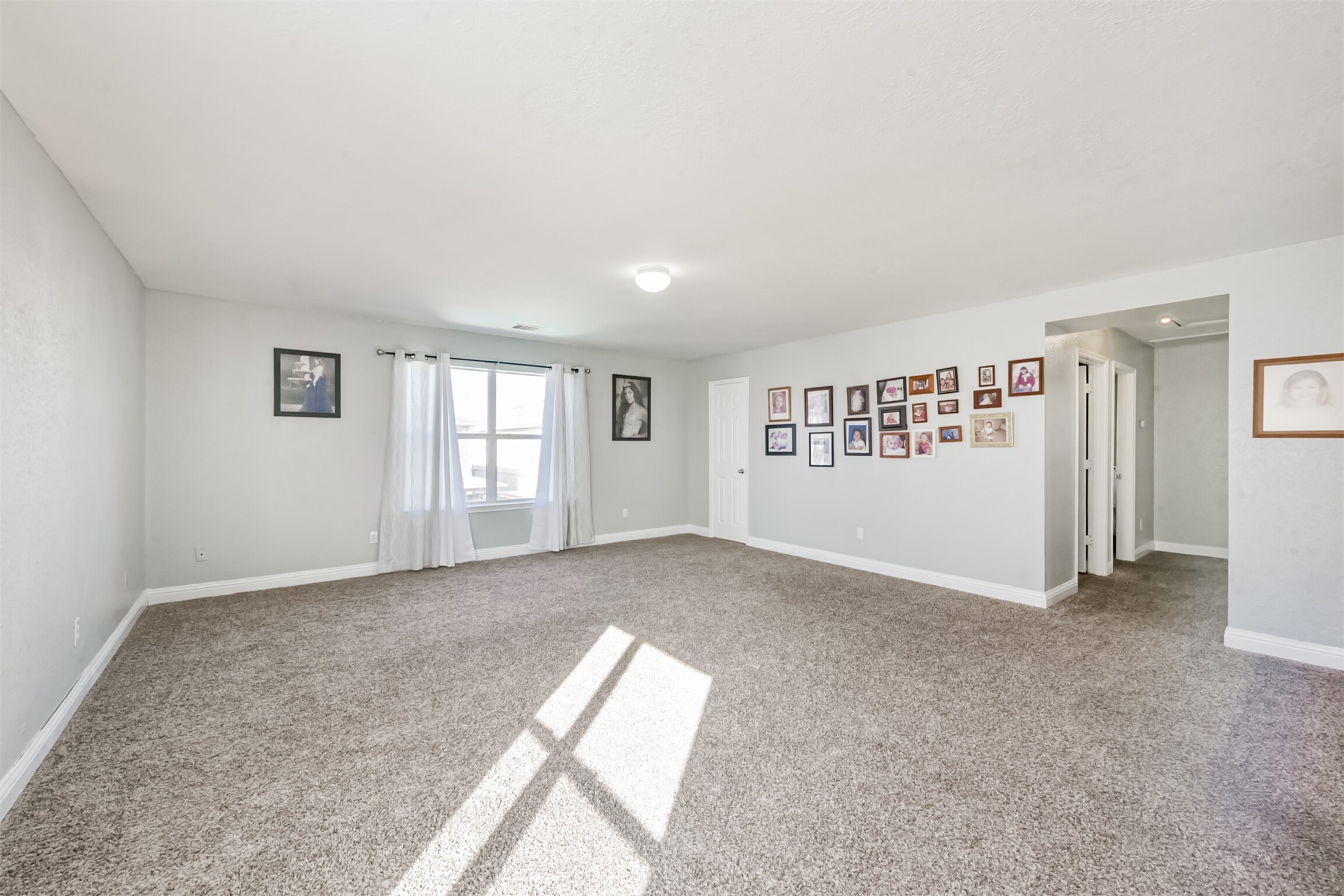 7015 Falling Cherry Place Houston, TX 77049 - Photo 24 of 42 an empty room with windows