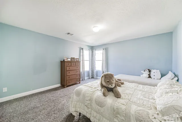 a bedroom with a bed and a lamp