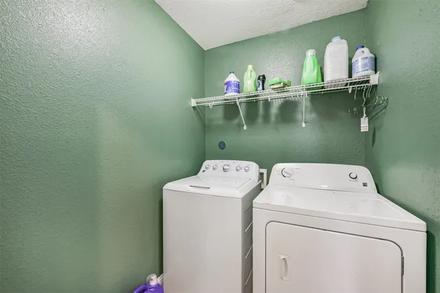 a patio with wooden table and chairs