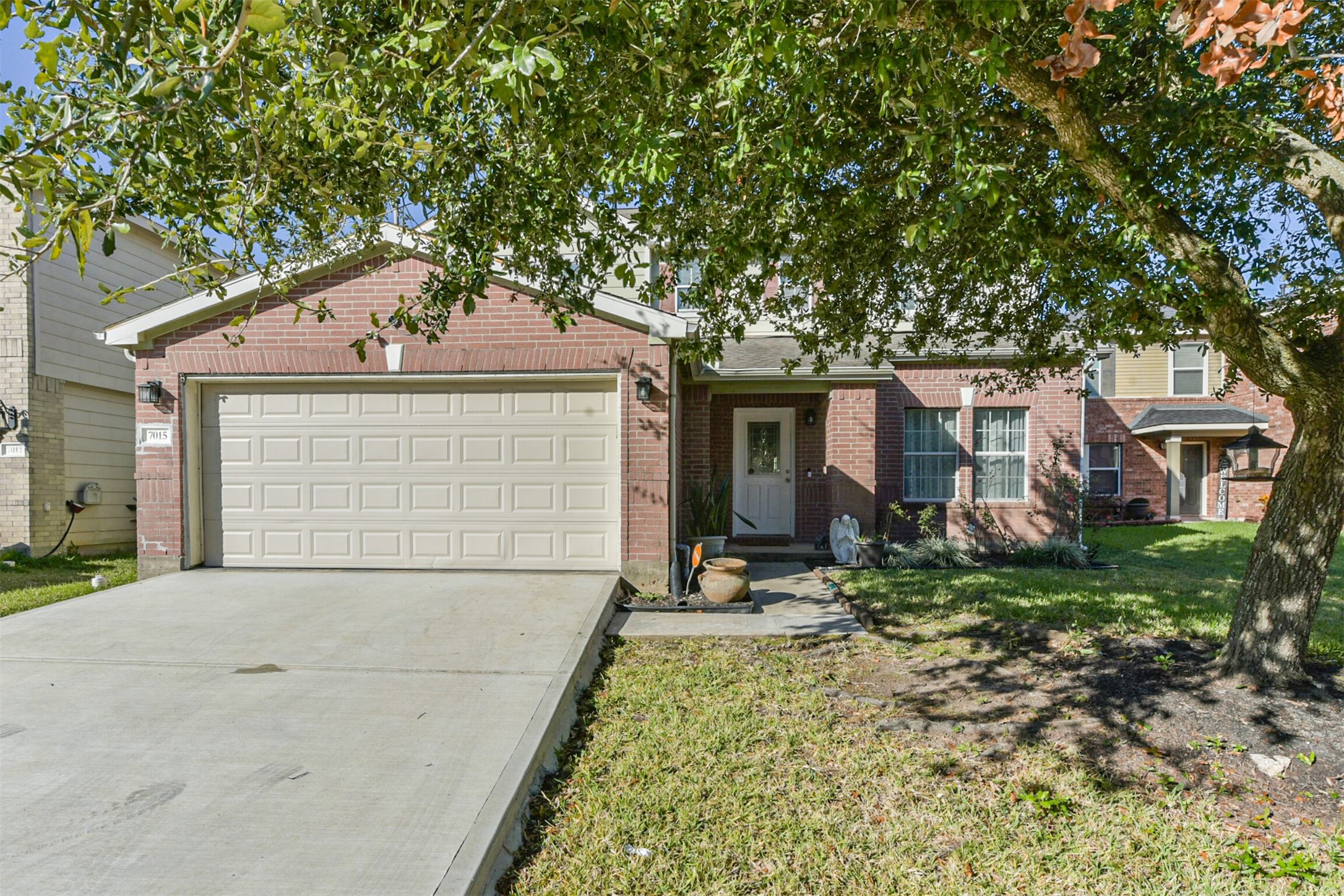 7015 Falling Cherry Place Houston, TX 77049 - Photo 4 of 42 a front view of a house with garden