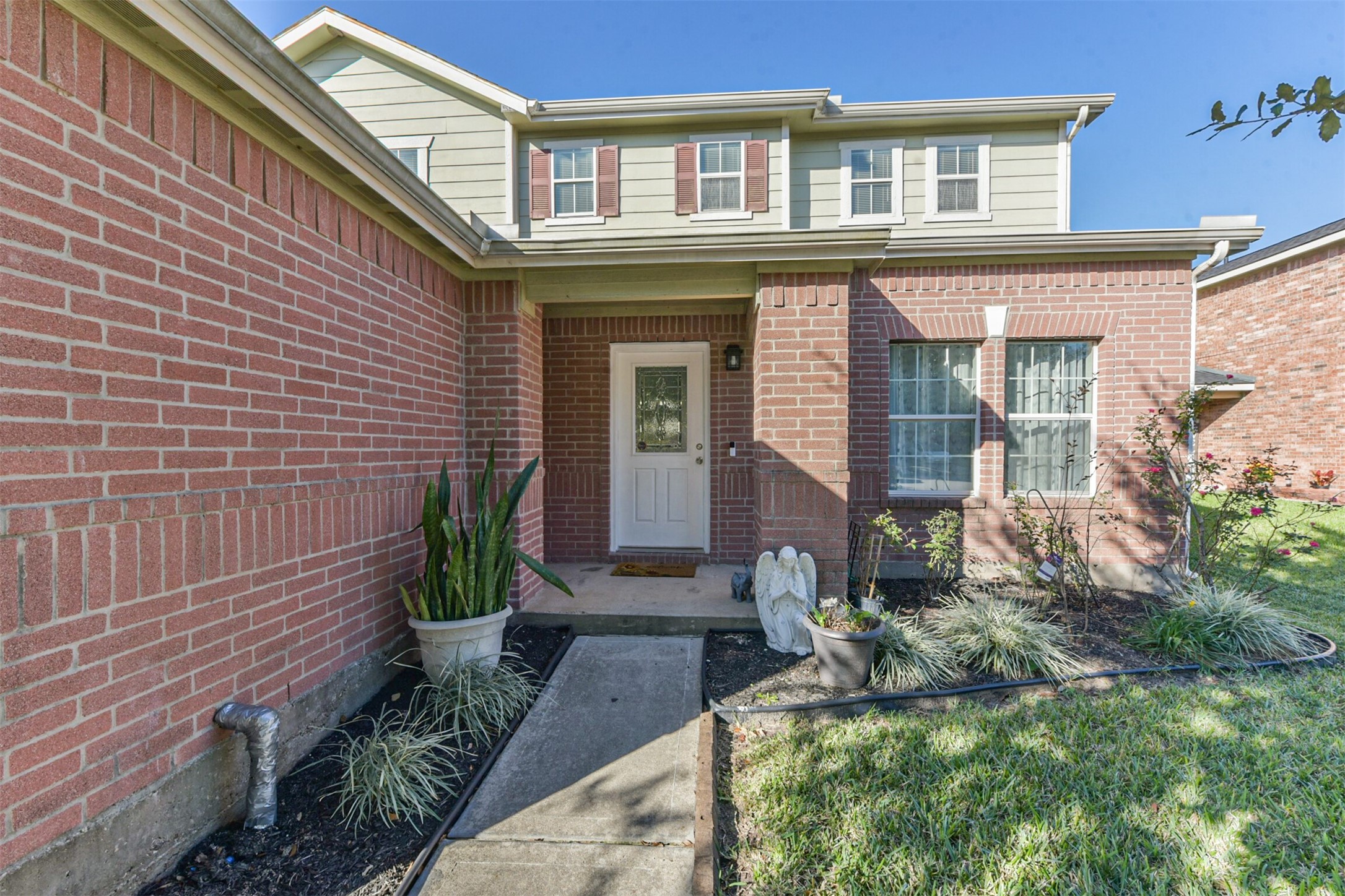 7015 Falling Cherry Place Houston, TX 77049 - Photo 6 of 42 a front view of a house with garden