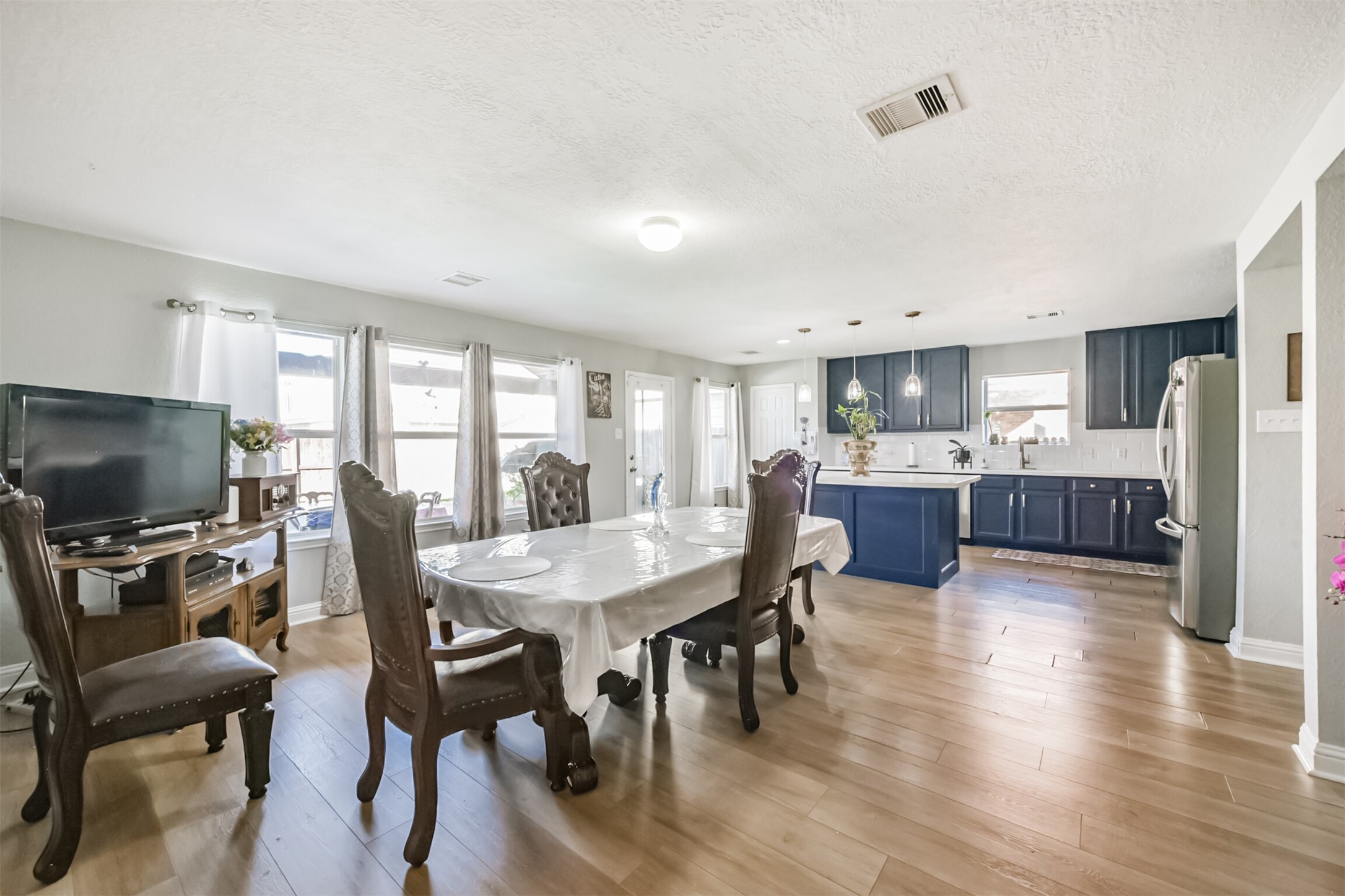 7015 Falling Cherry Place Houston, TX 77049 - Photo 10 of 42 a view of a dining room with furniture and wooden floor