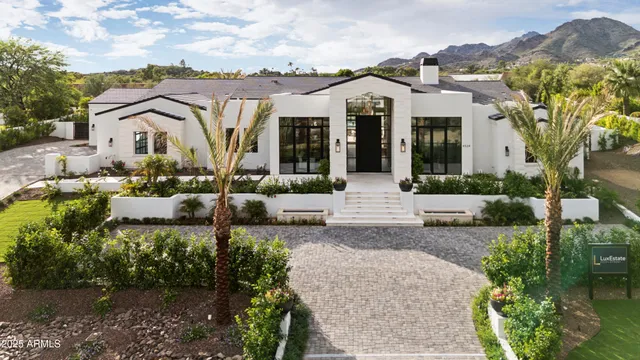 a view of a house with swimming pool and furniture