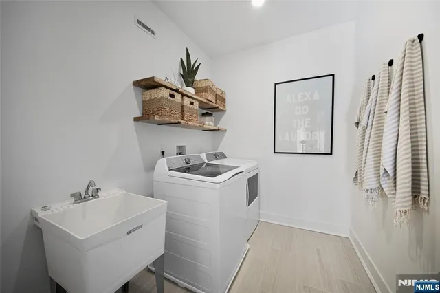 a view of a sink and utility room with a sink