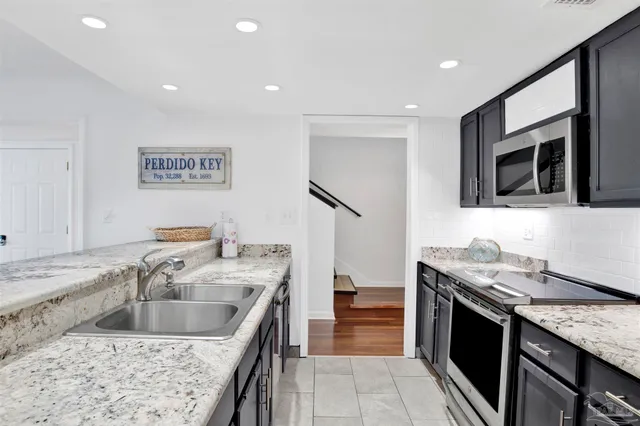 a kitchen that has a sink and a stove in it