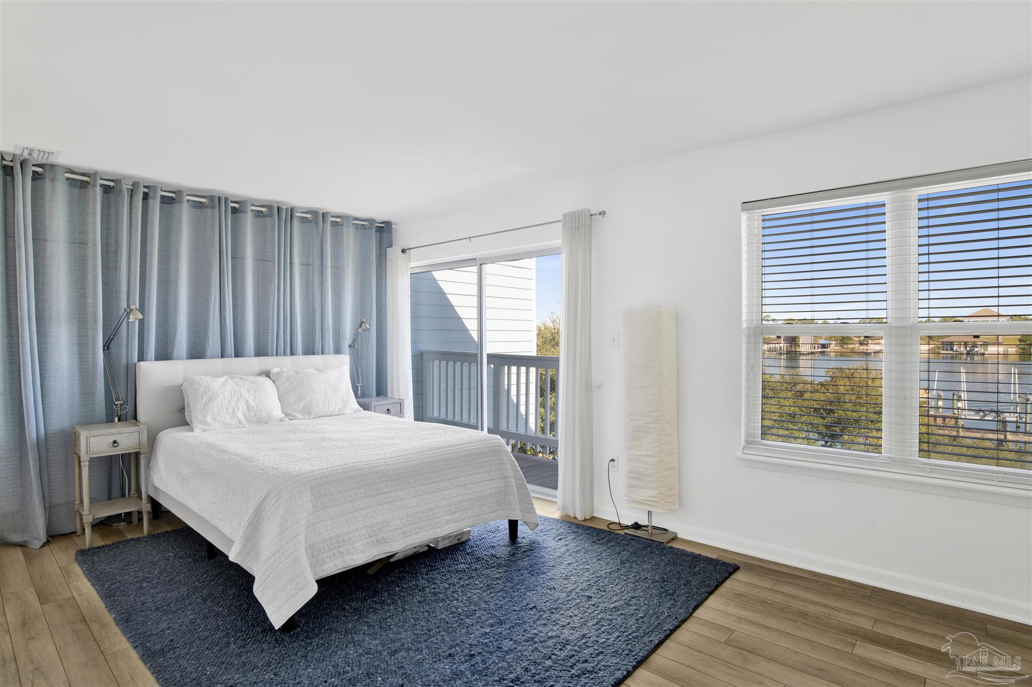 16784 Perdido Key Drive, Unit 9 Pensacola, FL 32507 - Photo 15 of 48 a large bedroom with a bed and wooden floor