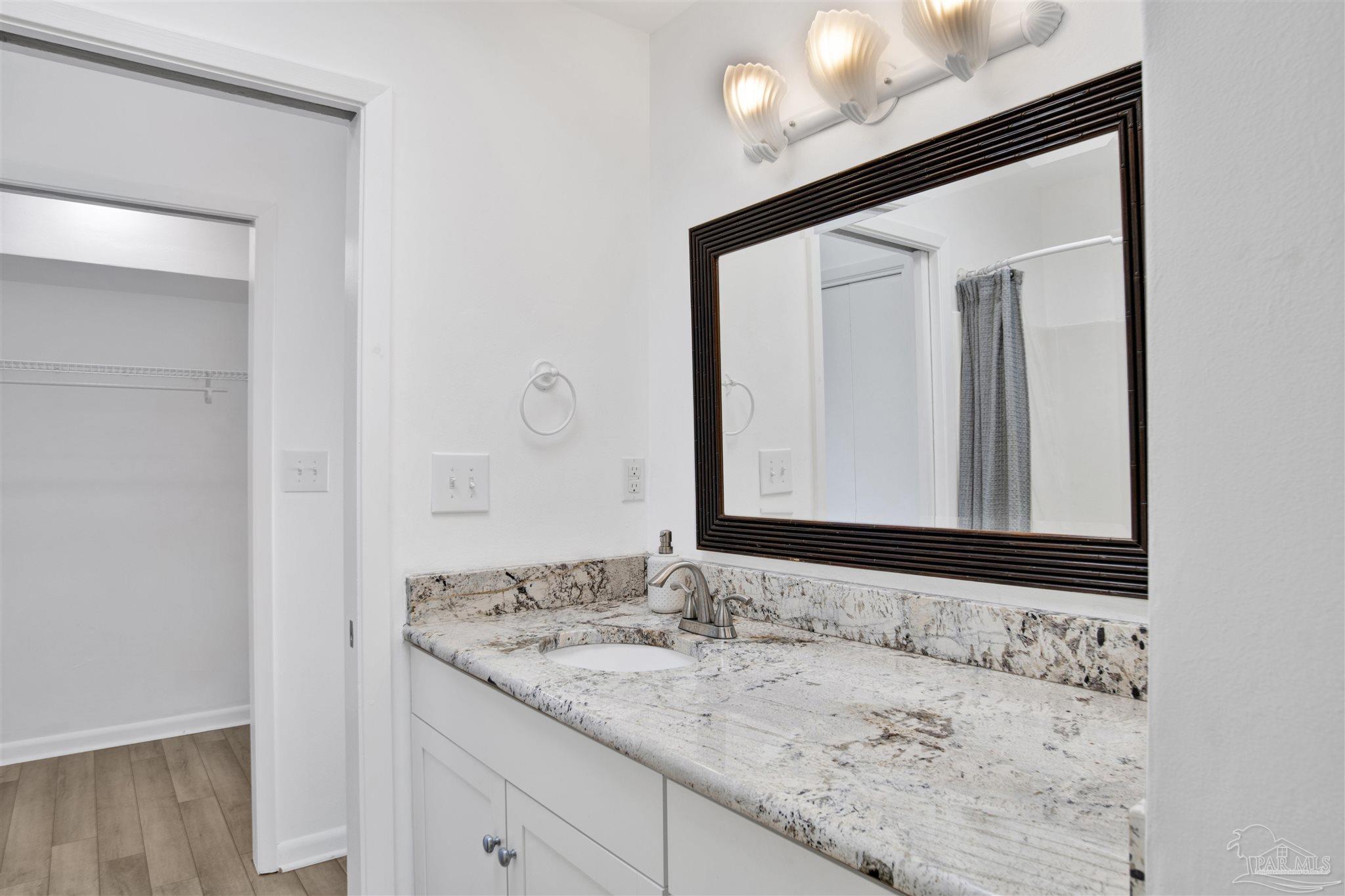16784 Perdido Key Drive, Unit 9 Pensacola, FL 32507 - Photo 18 of 48 a bathroom with a granite countertop sink and a mirror