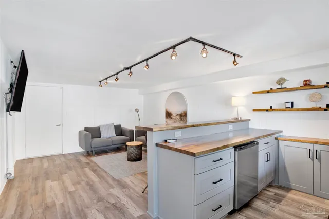 a room with a table chairs and wooden floor