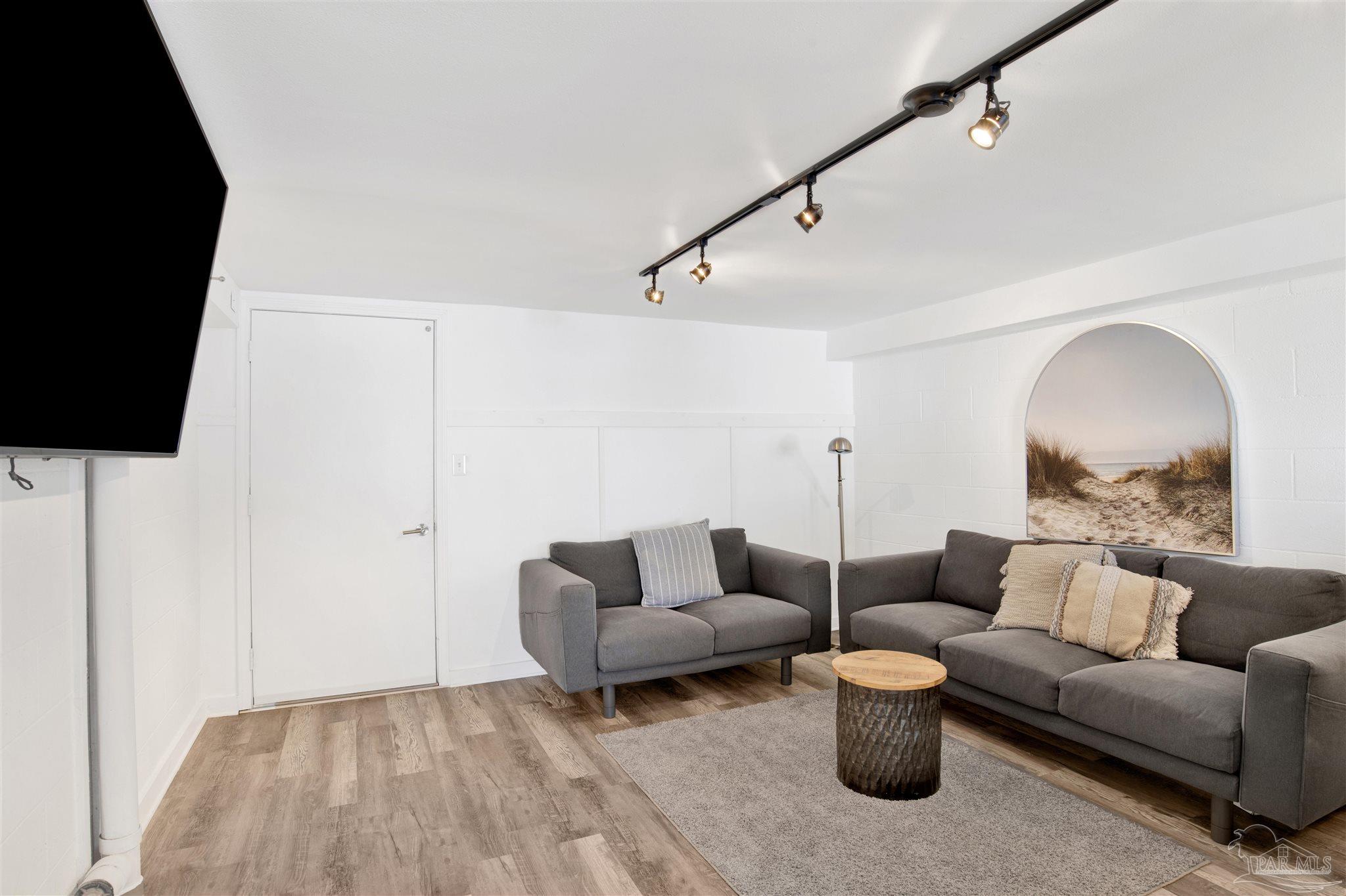 16784 Perdido Key Drive, Unit 9 Pensacola, FL 32507 - Photo 23 of 48 a living room with furniture and a flat screen tv