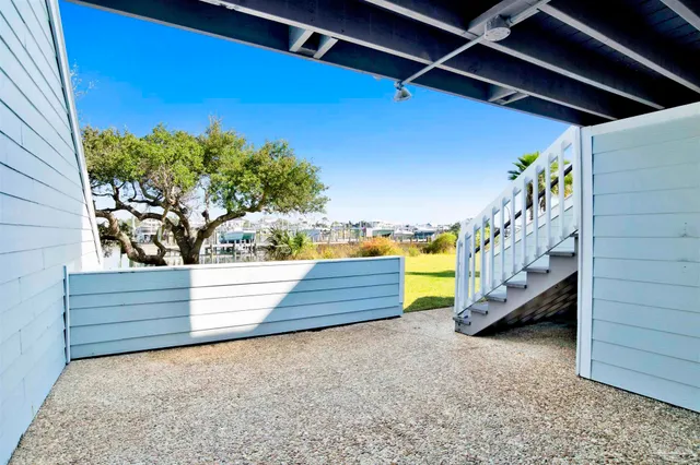 a view of a house with pool and chairs