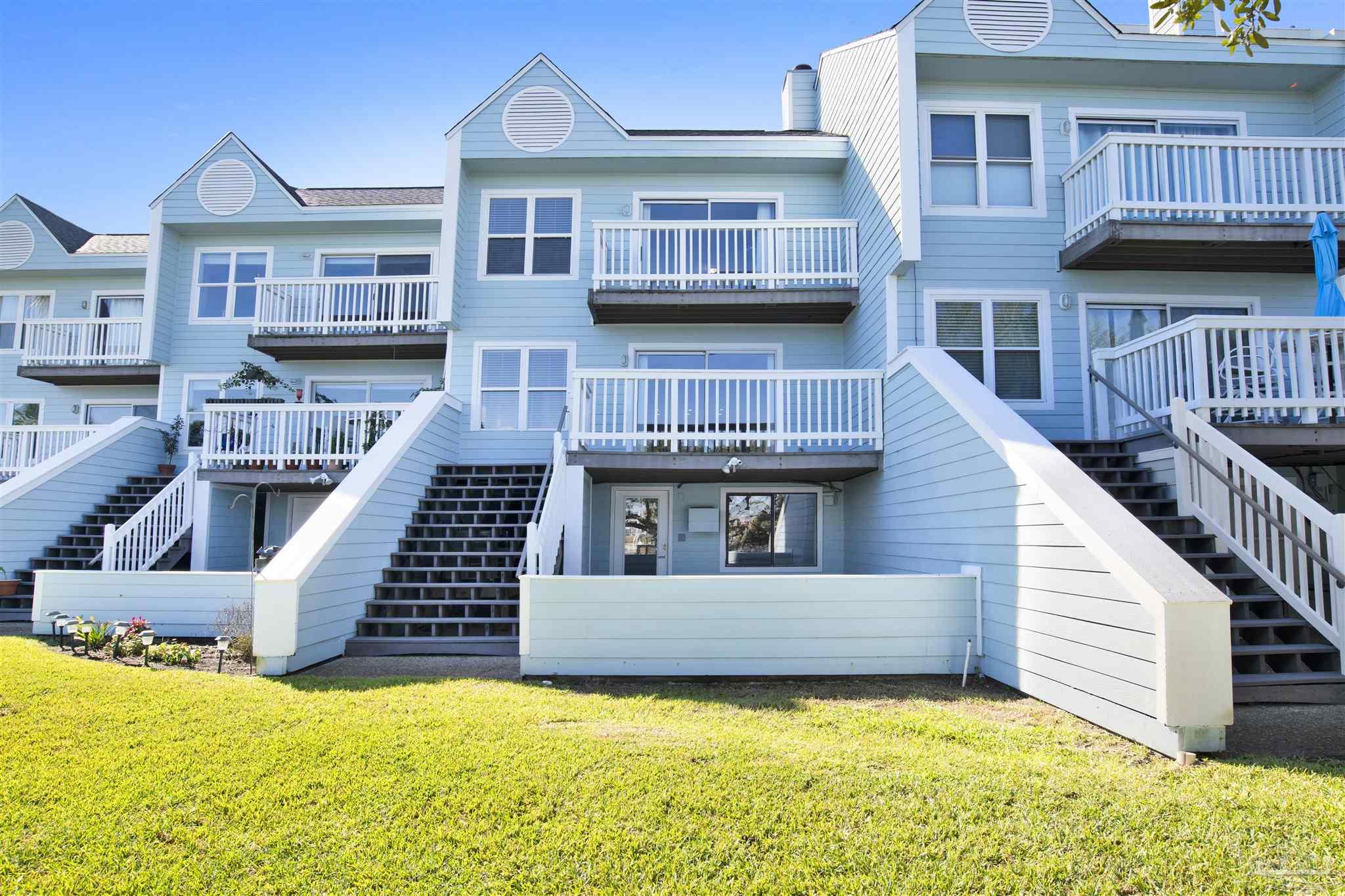 16784 Perdido Key Drive, Unit 9 Pensacola, FL 32507 - Photo 25 of 48 a view of a house with pool and chairs