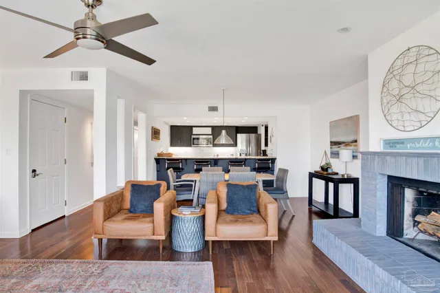a living room with furniture a fireplace and a table