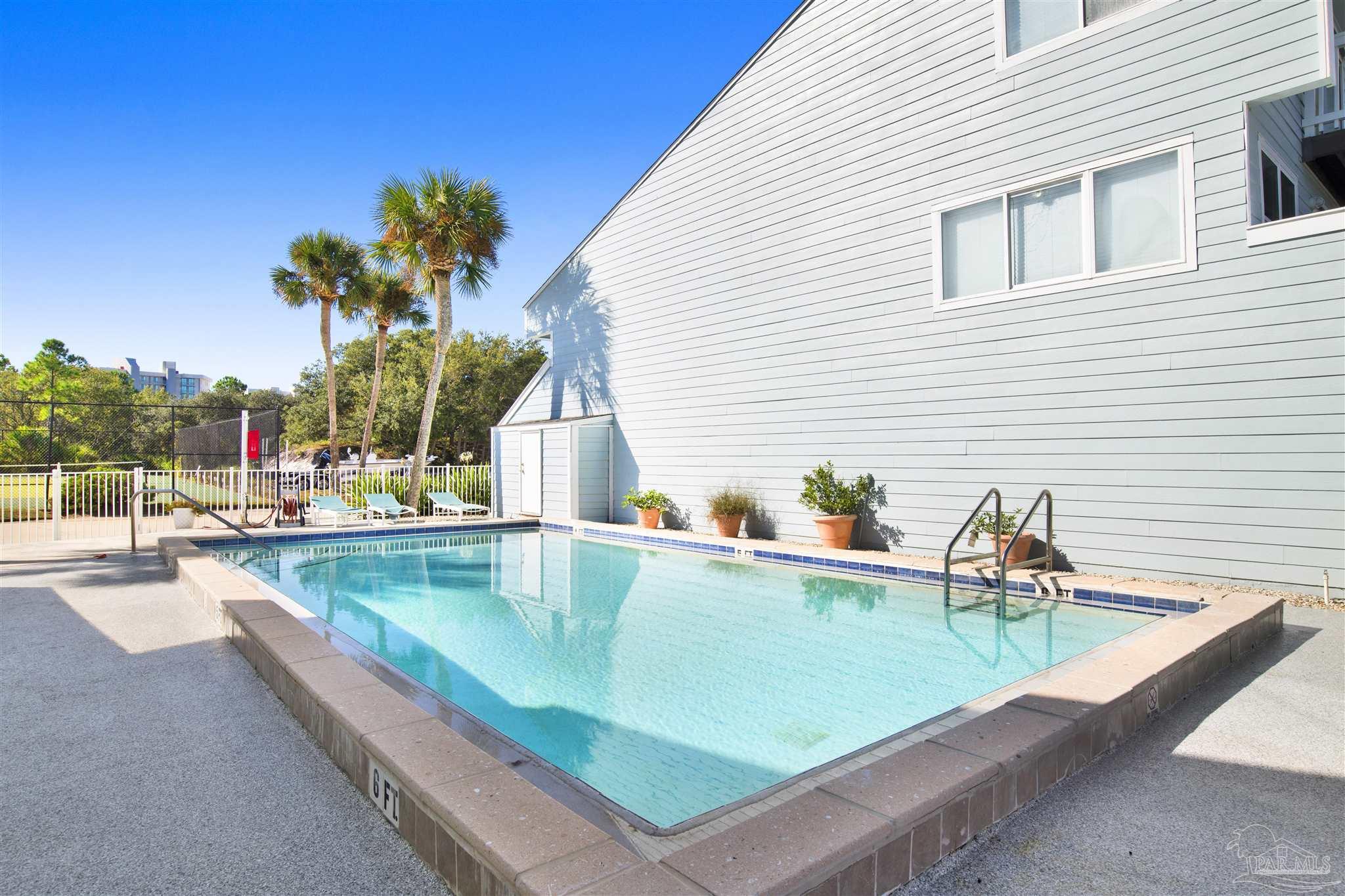 16784 Perdido Key Drive, Unit 9 Pensacola, FL 32507 - Photo 31 of 48 a view of a swimming pool with a sitting space