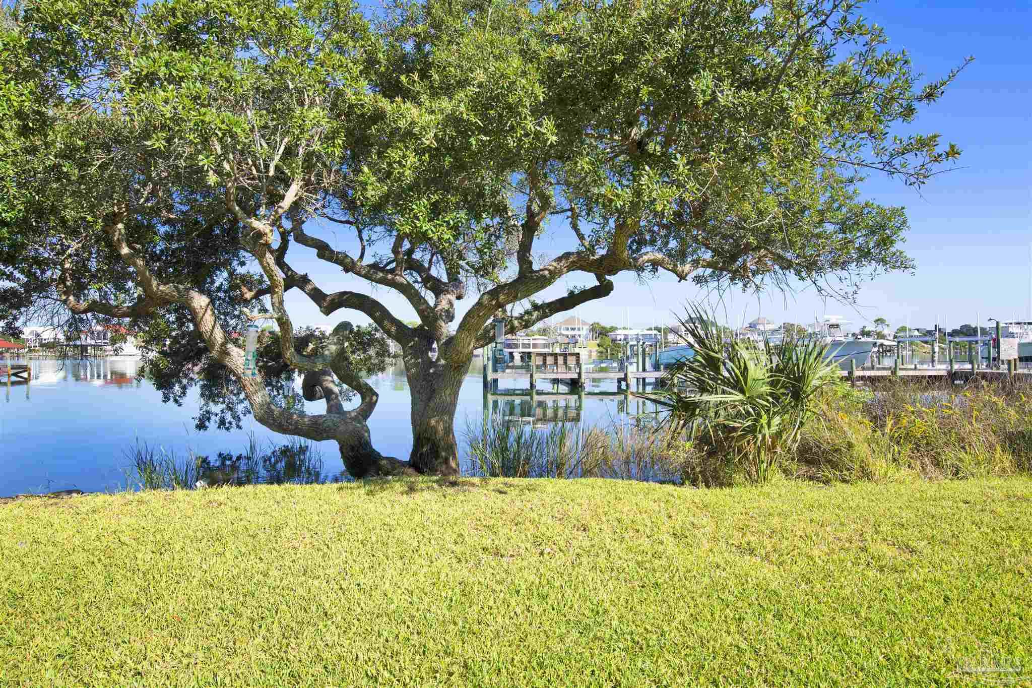 16784 Perdido Key Drive, Unit 9 Pensacola, FL 32507 - Photo 32 of 48 a front view of a house with a yard