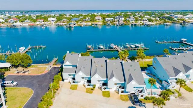 a view of a swimming pool with outdoor seating and a garden