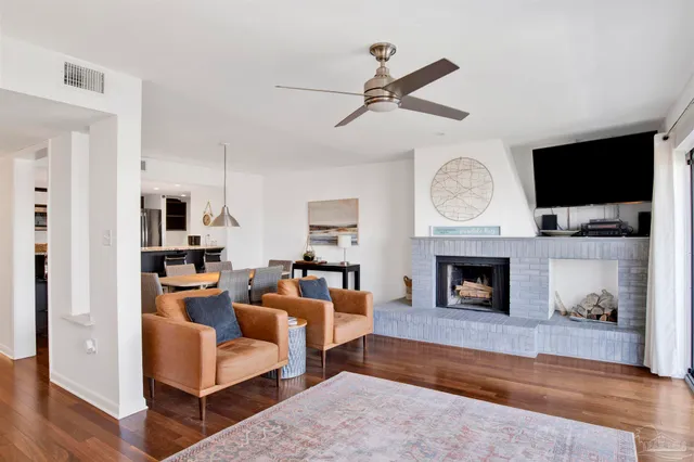 a living room with furniture a fireplace and a flat screen tv
