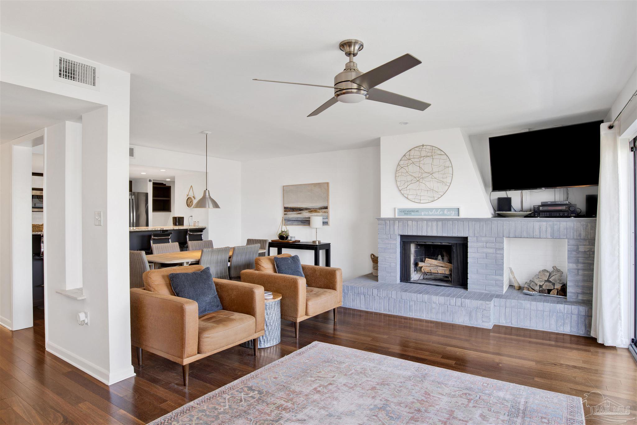 16784 Perdido Key Drive, Unit 9 Pensacola, FL 32507 - Photo 5 of 48 a living room with furniture a fireplace and a flat screen tv