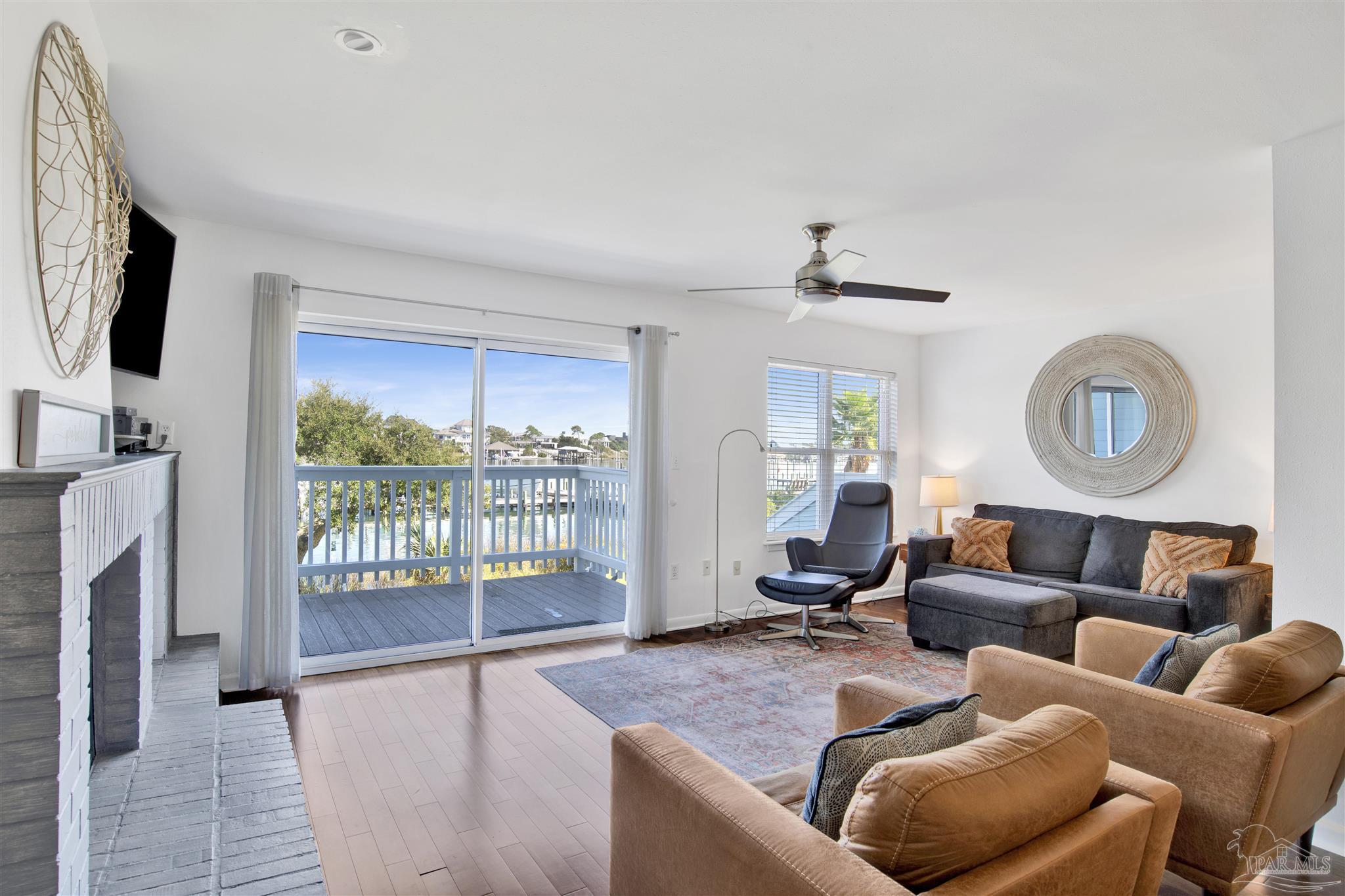 16784 Perdido Key Drive, Unit 9 Pensacola, FL 32507 - Photo 6 of 48 a living room with furniture and a flat screen tv