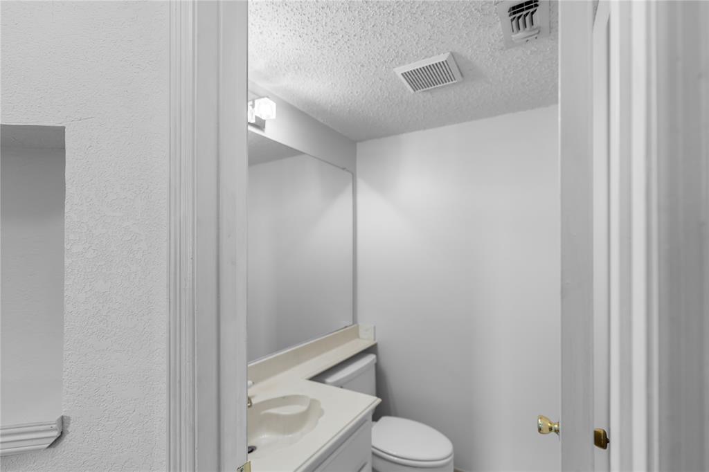9447 Abbey Road Irving, TX 75063 - Photo 23 of 40 a bathroom with a toilet and a shower
