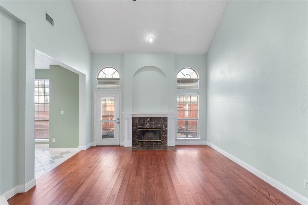 9447 Abbey Road Irving, TX 75063 - Photo 8 of 40 wooden floor fireplace and windows in a room